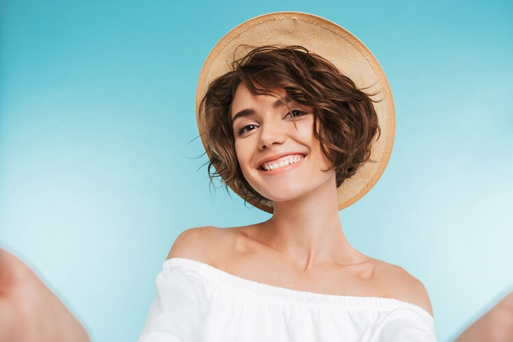 902portrait-smiling-young-woman-taking-selfie